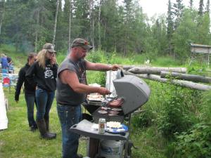 Mike grilling up some awesome moose burgers and elk sausages!