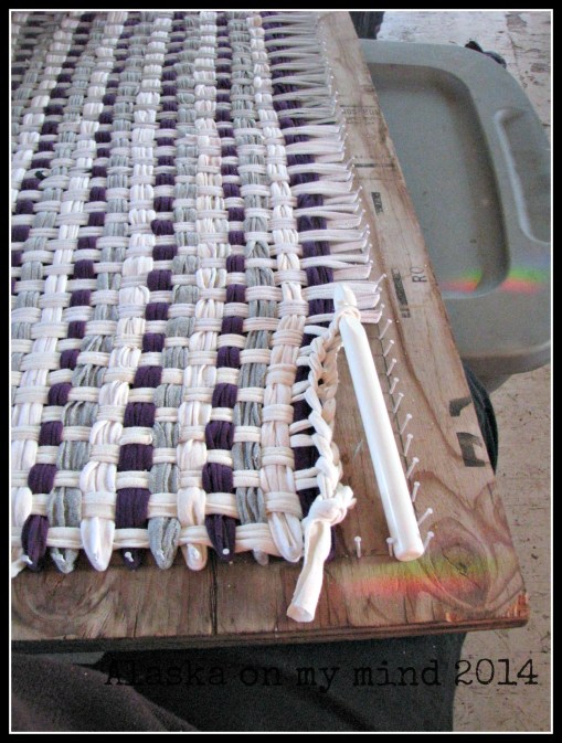 Crocheting the edge of the rag rug.